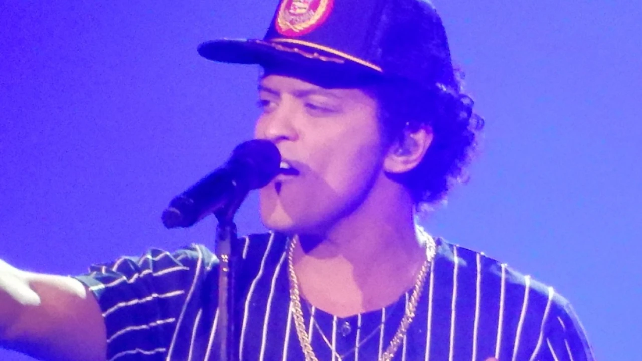 Bruno Mars 2026-2027 Tour & Schedule featuring Bruno Mars live on stage with stadium crowd
